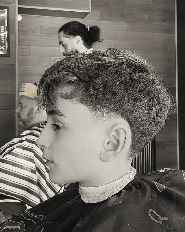 A boy with a textured fringe and tapered sides.